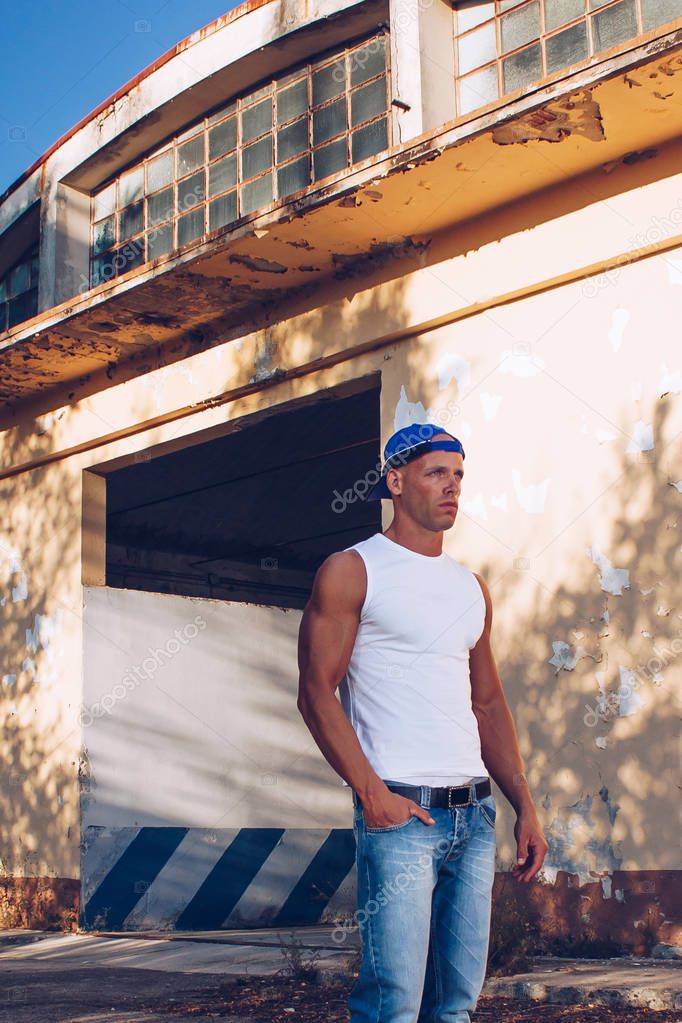 handsome sexy muscular man wearing denim jeans. Fitness male with healthy tan posing.