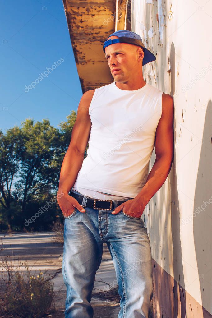 handsome sexy muscular man wearing denim jeans. Fitness male with healthy tan posing.