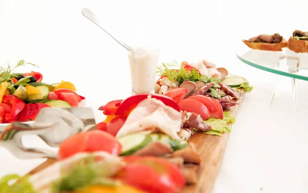 Assorted meat and vegetables on the banquet table — Stock Photo, Image