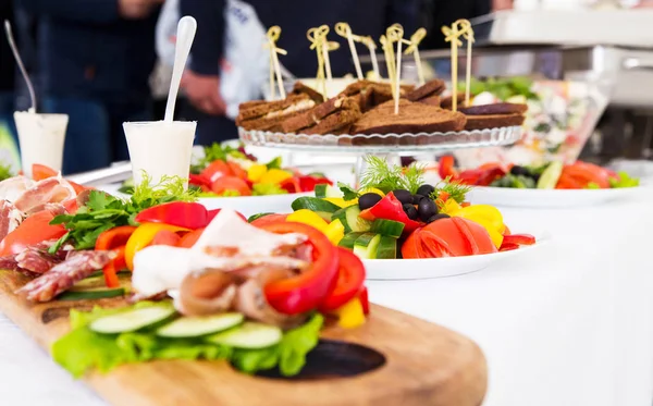 Assorted meat and vegetables on the banquet table — Stock Photo, Image
