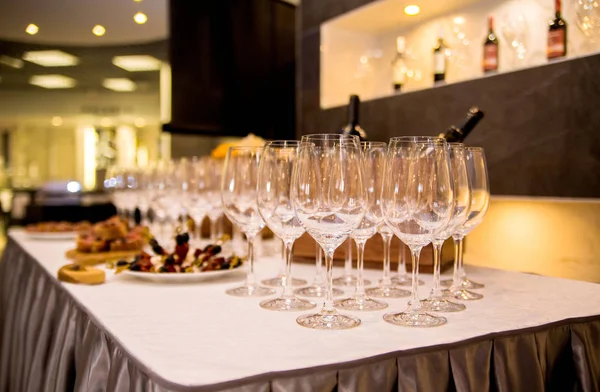 the table is covered with appetizers and glasses for wine