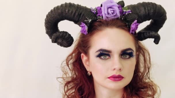 Girl in a fairy-tale image with horns on her head — Stock Video