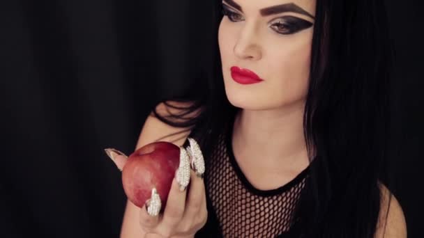 Une jeune sorcière avec une pomme dans les mains — Video