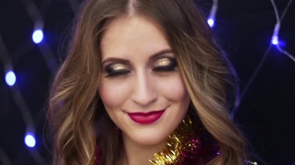 Niña sonriendo en el fondo de las luces de Navidad — Vídeos de Stock