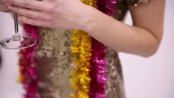 Beyaz bir arka plan üzerinde Noel tinsel ile parlak elbiseli kız — Stok video