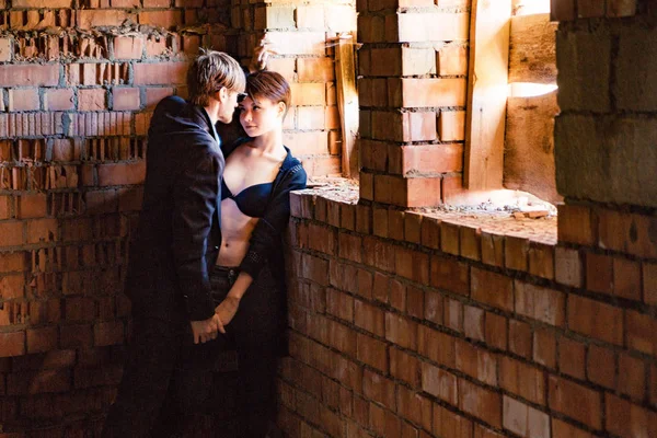 Ragazzo e ragazza sono in posa nelle pareti di una vecchia casa — Foto Stock