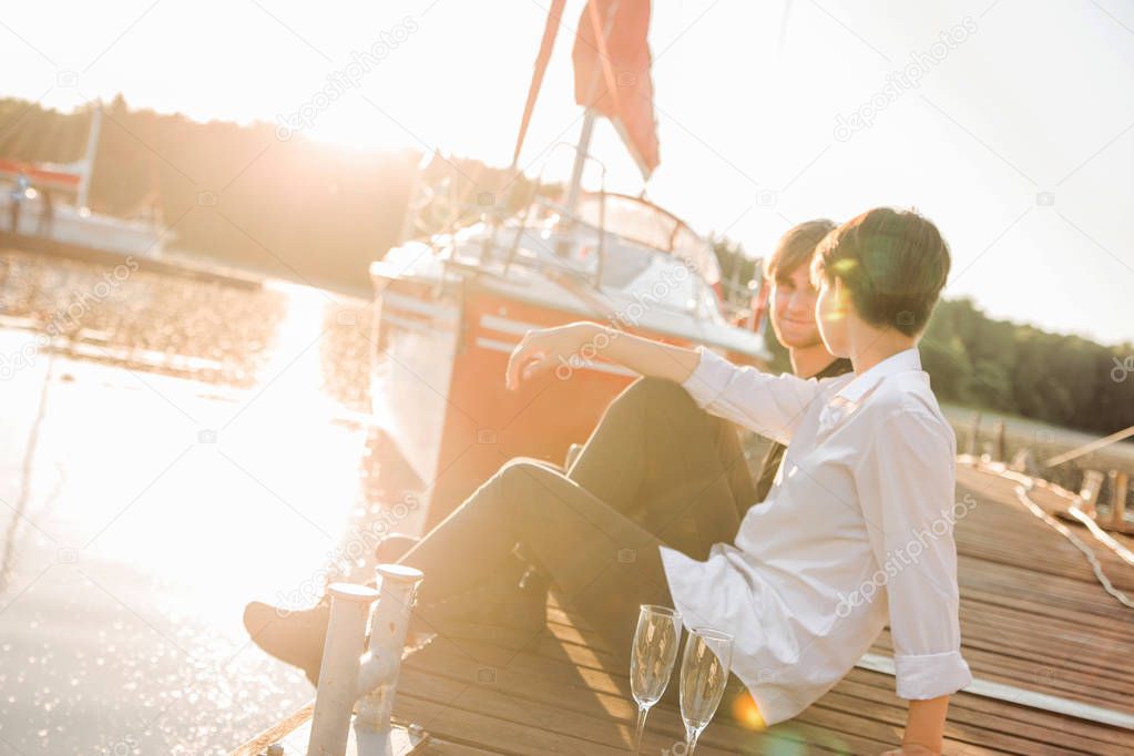 couple in love drinking champagne on the dock