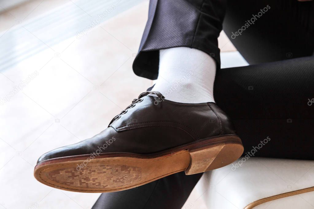 photo of man in a suit sitting cross legged