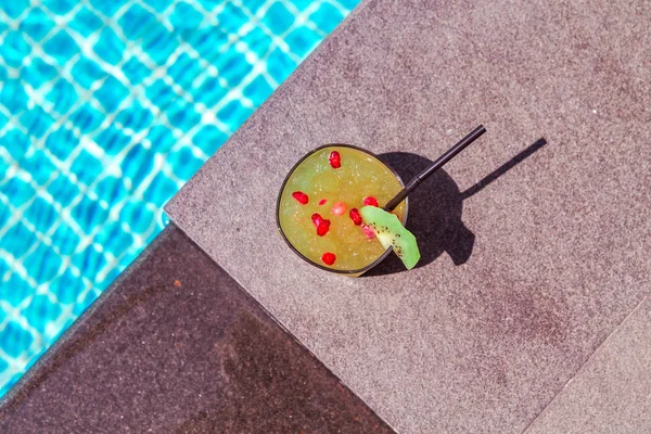 Photo of Yellow cocktail near the swimming pool