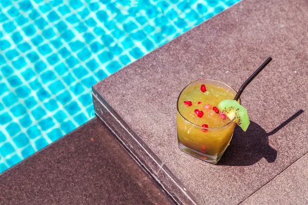 Photo of Yellow cocktail near the swimming pool