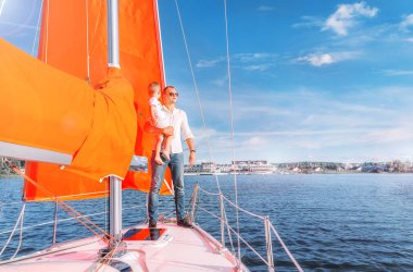 bir yatın güvertesinde duran Beyaz gömlekli bir adam