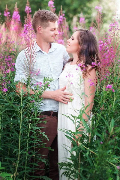 Lovers man and woman in the flowers of willow-tea — Stock Photo, Image