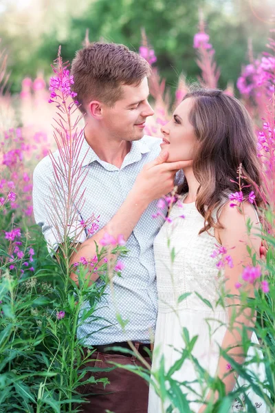 Lovers man and woman in the flowers of willow-tea — Stock Photo, Image