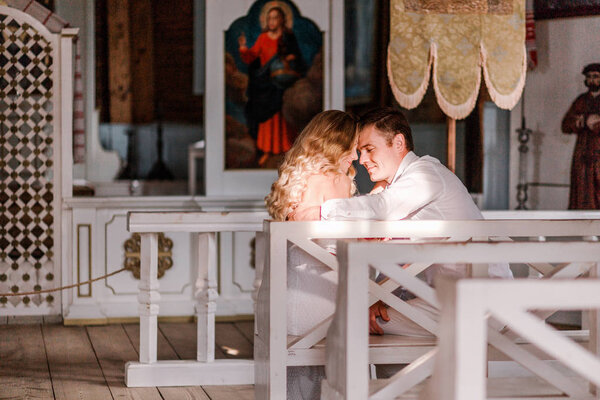 Bride and groom together in church. Horizontal photo