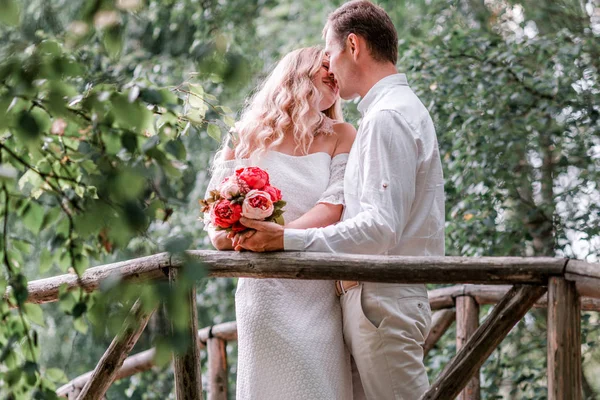 Groom bride posing on a wooden bridge — Stock Photo, Image