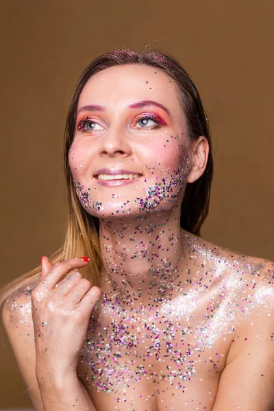 Happy fashion model woman with trendy glitter make-up
