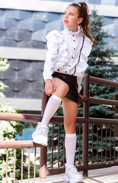 Fashionable Schoolgirl White Blouse Leather Shorts Socks Sports Shoes Sits — Stock Photo, Image