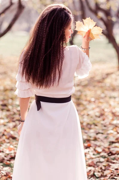 Beautiful Brunette Girl Long Hair White Dress Looks Autumn Yellow — Stock Photo, Image