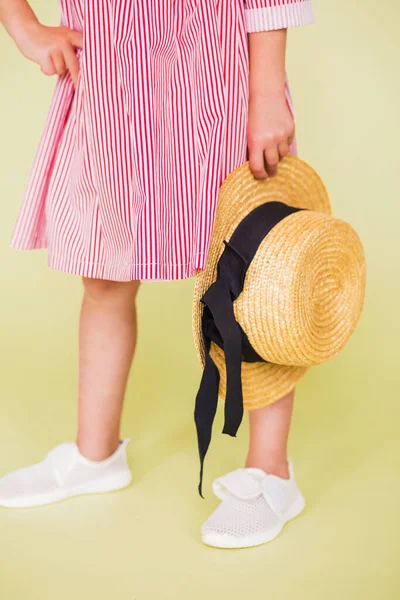 Ένα Κορίτσι Κόκκινα Και Άσπρα Αθλητικά Κρατά Ένα Ψάθινο Καπέλο — Φωτογραφία Αρχείου