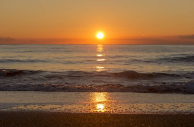 Sunrise on a beach in Denia, Alicante, Spain clipart