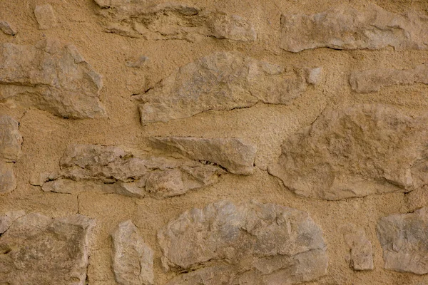 Un fondo con una pared de piedra con tono marrón — Foto de Stock