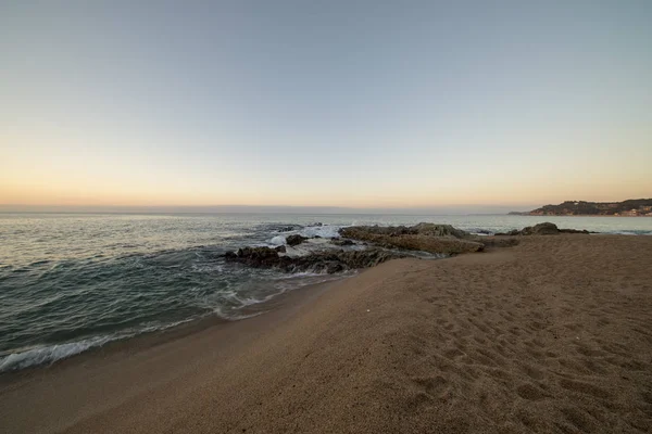 Východ slunce na pláži Lloret de Mar — Stock fotografie