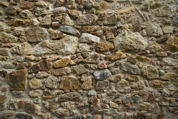 Uno sfondo con le pietre di un muro — Foto Stock