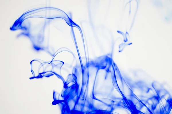 stock image clouds of blue smoke over white background