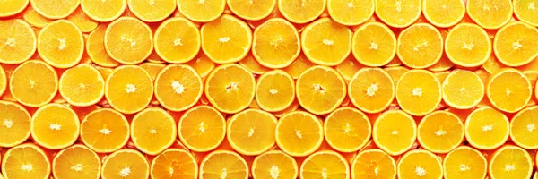 Creative pattern. Fresh sliced orange fruit texture. Macro, top view with copy space. Food frame. Juicy oranges background. banner