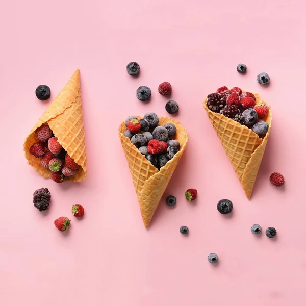 Frozen berries - strawberry, blueberry, blackberry, raspberry in waffle cones on pink background. Top view. Banner. Pattern for minimal style. Pop art design, creative concept — Stock Photo, Image
