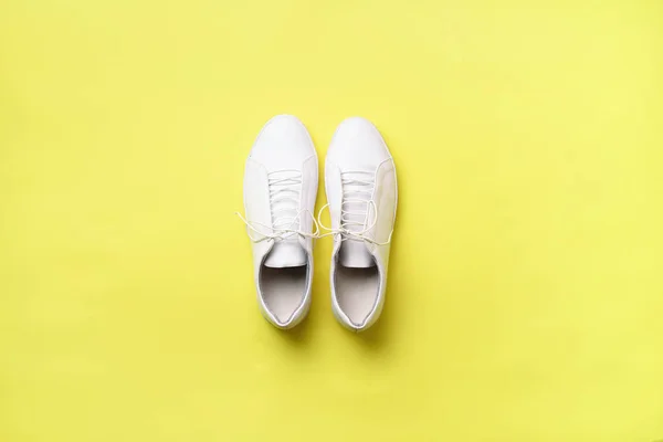 Stylish white sneakers and rope on yellow background with copy space. Top view. Minimal flat lay. Summer shoes collection. First step concept — Stock Photo, Image