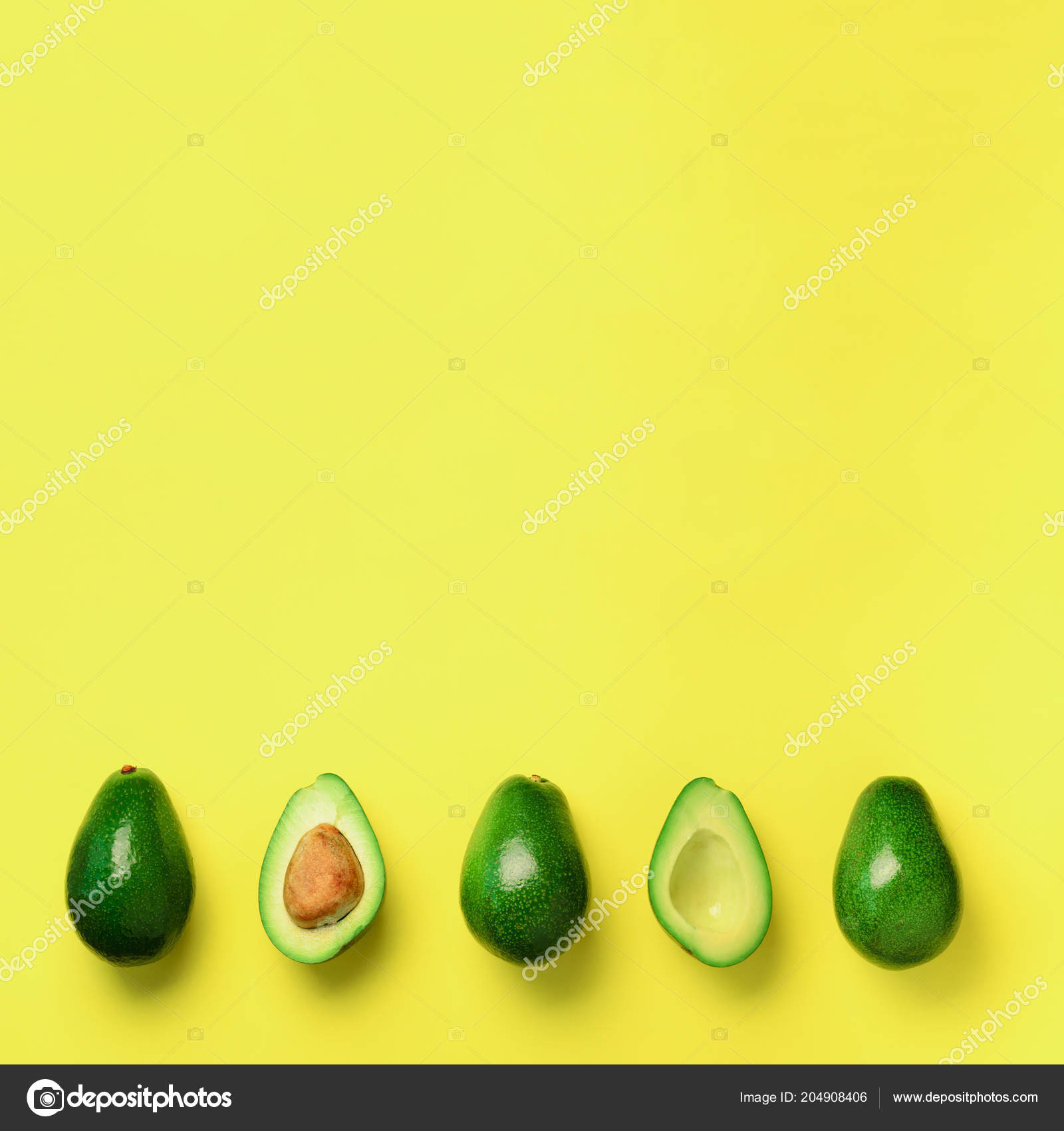Organic avocado with seed, avocado halves and whole fruits on yellow  background. Top view. Square crop. Pop art design, creative summer food  concept. Green avocadoes pattern in minimal flat lay style. Stock