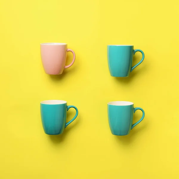 Pattern from blue and pink cups over yellow background. Square crop. Birthday party celebration, baby shower concept. Punchy pastel colors. Minimalist style design — Stock Photo, Image