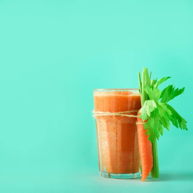 Taze organik havuç suyu ile havuç, kereviz mavi zemin üzerine. Kare ürün. Sebze smothie cam. Afiş. Uzay kopyalayın. Yaz gıda kavramı. Yeme, alkali diyet sağlıklı detoks