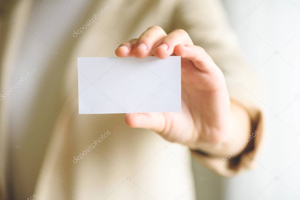 Businessman holding empty business card with copy space. Mock up. Business, study, network concept.