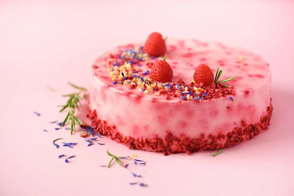 Pink marble cake with raspberries, dry flowers, rosemary. Copy space for your text