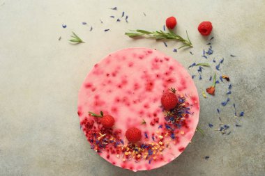 Taze çilek, biberiye ve gri beton zemin üzerine kuru çiçekler ile lezzetli frambuazlı pasta. Alan metni kopyalayın. Vejetaryen, vegan gıda kavramı.