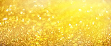 Altın gibi parlak arka plan, Noel kutlamaları için fotokopi alanı. Işıkları sönmüş, parlak sarı bokeh 'li pankart. Altın parıltısı dokusu parıldıyor. Yeni yıl kavramı, lüks tatil