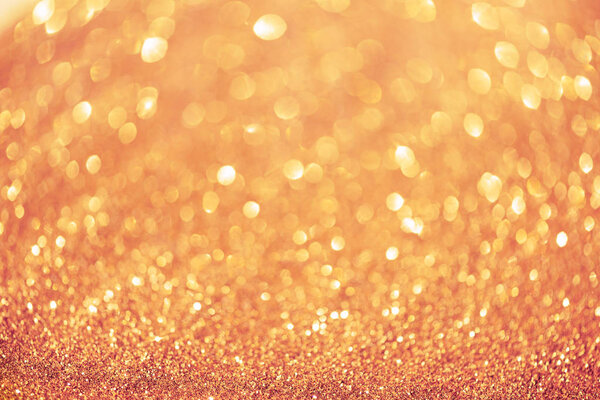 Pink and gold abstract bokeh lights. Shiny glitter background with copy space. New year and Christmas concept. Sparkling greeting card