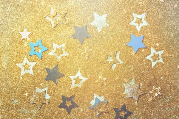 Blue, yellow stars on gold background with bokeh. Texture for new year, birthday, baby shower party. Creative pattern. Banner