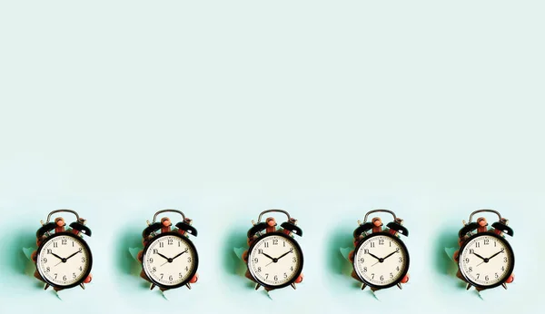 Pattern Hands Holding Black Alarm Clock Hole Blue Paper Background — 스톡 사진