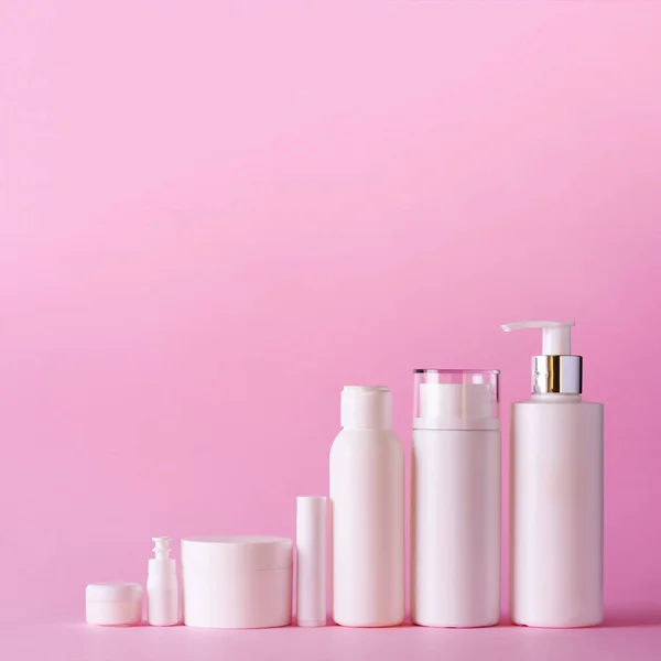 White cosmetic tubes on pink background with copy space. Skin care, body treatment, beauty concept. Square crop — Stock Photo, Image