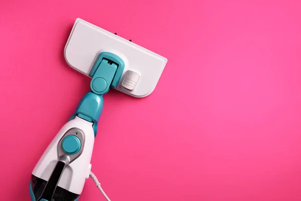 Steam cleaner mop on pink background. Top view, flat lay. Banner with copy space. Cleaning service concept