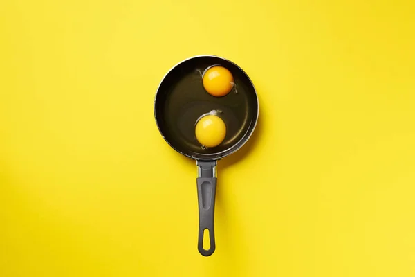 Food concept with two eggs, pan on yellow background. Top view. Creative pattern in minimal style. Flat lay. — 스톡 사진