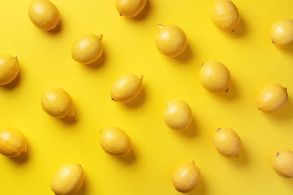 Food pattern with lemons on yellow paper background. Top view. Summer concept. Vegan and vegetarian diet