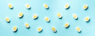 Mavi arka planda haşlanmış yumurta desenli yemek konsepti. Üst Manzara. Asgari tarzda yaratıcı bir model. Düz yatıyordu. Pankart
