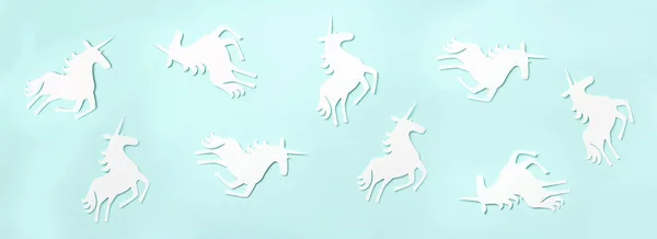 Creative unicorn pattern on blue background. Abstract art texture Minimal fantasy concept. Banner. Top view