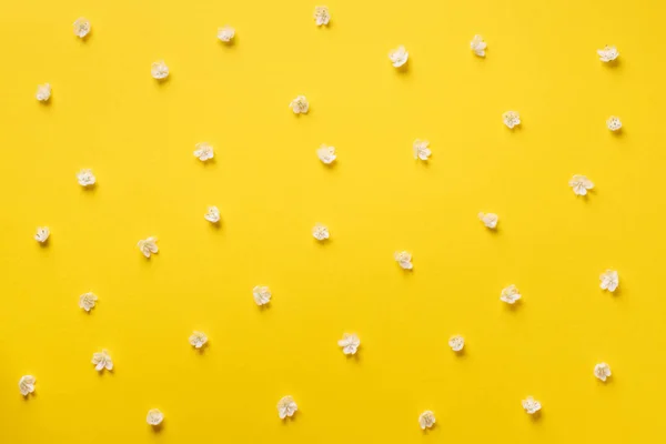 Daisy pattern. Top view. Flat lay. Floral pattern of white chamomile flowers on yellow background. Summer concept