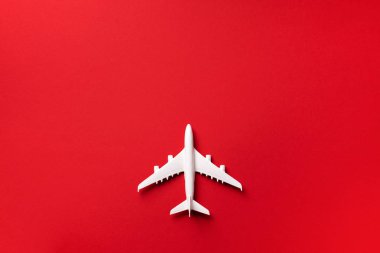 Yaratıcı düzen. Beyaz model uçak manzarası, pembe pastel arka planda uçak oyuncağı. Fotokopi alanı olan düz bir yer. Yaz gezisi veya seyahat konsepti