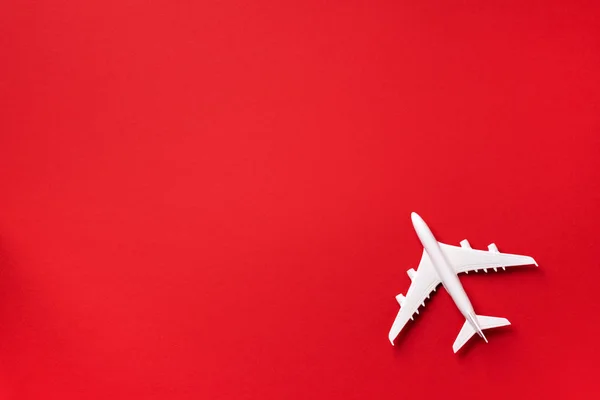 White plane, airplane on red color background with copy space. Top view, flat lay. Minimal style design. Travel, vacation concept — 스톡 사진